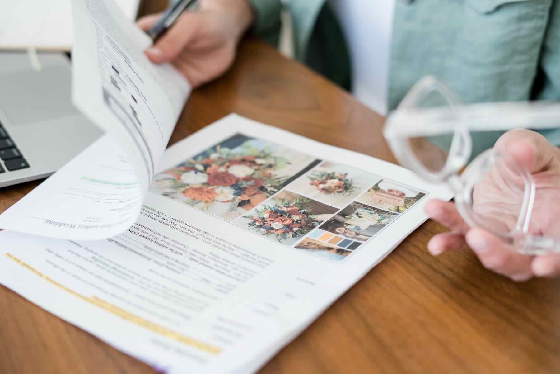 Wendee reviewing a printed personalized wedding plan with a couple