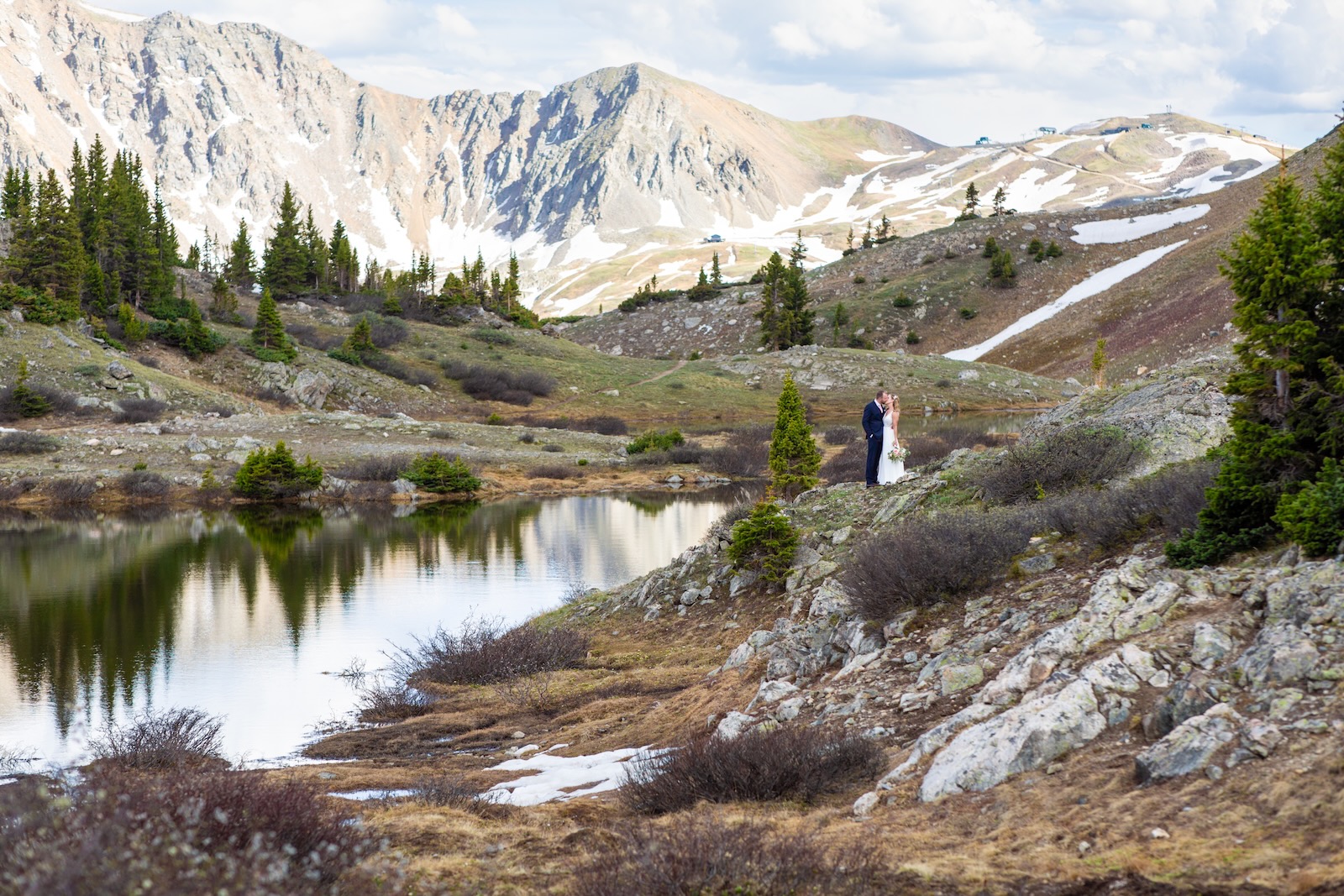 A couple at a Colorado alpine lake after their national park ceremony